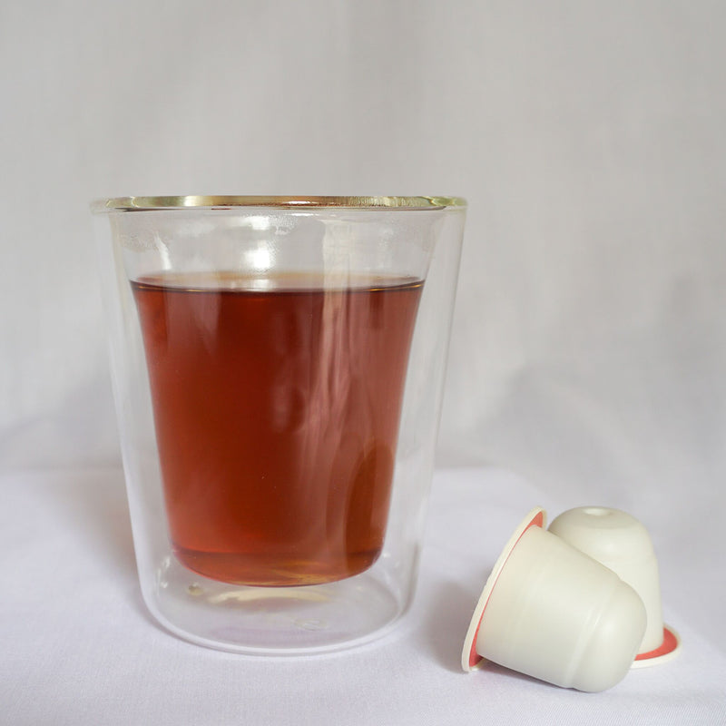 A cup of Thee's Supu'er Auspicious tea blend with Nespresso® compatible tea pods