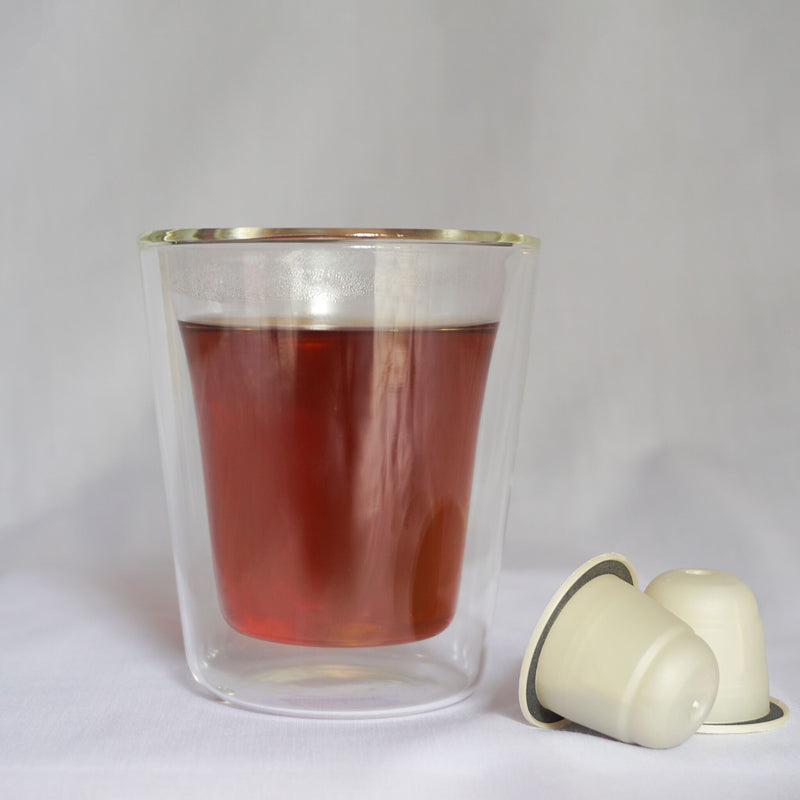 A cup of Thee's Honey Granate tea blend with Nespresso® compatible tea pods